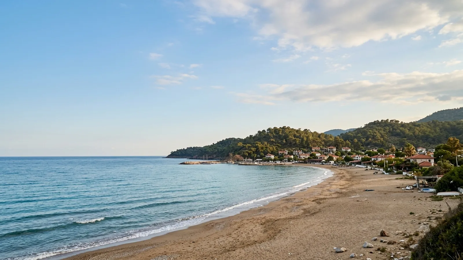 Cenger, Türkiye — the small coastal settlement of Cenger east of Manavgat, a sandy beach with low wooded hills rising close behind it.