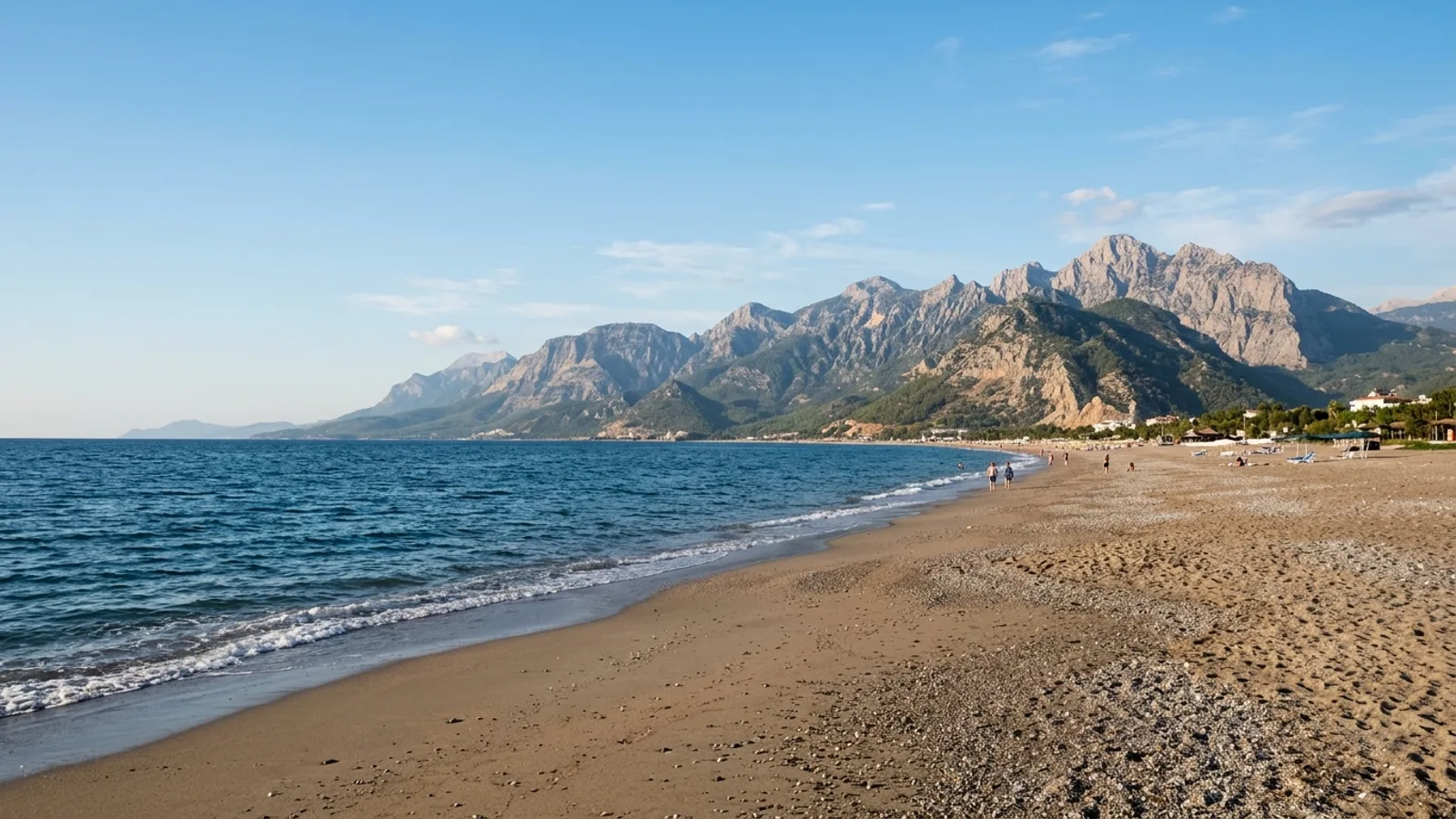 Konakli, Türkiye — the beach at Konakli west of Alanya, a long sand and shingle shore with mountains rising steeply a short way inland.