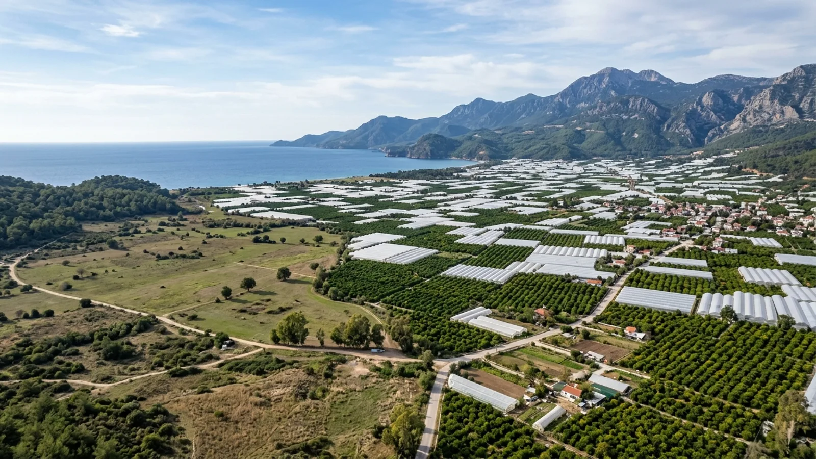 Kumluca, Türkiye — the plain at Kumluca on the western Antalya coast, a landscape of greenhouses and citrus groves between the mountains and the sea.